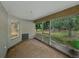 Screened lanai featuring natural light and serene views of the surrounding greenery at 5522 1St Se St, Lakeland, FL 33812
