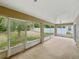 Enclosed patio overlooking a fenced yard with beautiful mature trees, providing a tranquil retreat at 5522 1St Se St, Lakeland, FL 33812