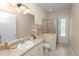 Bright bathroom featuring a glass shower, tile flooring, vanity, ample lighting, and decorative towels at 6217 Ashley Dr, Lakeland, FL 33813