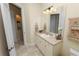 Well-lit bathroom featuring a vanity, large mirror, ample lighting, tile flooring, and decorative towels at 6217 Ashley Dr, Lakeland, FL 33813