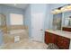 Spacious bathroom featuring a soaking tub, vanity, ample lighting, and tile flooring at 6217 Ashley Dr, Lakeland, FL 33813