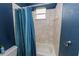 Well-maintained bathroom showcasing tiled walls, a bathtub with a shower, and a fabric shower curtain at 6217 Ashley Dr, Lakeland, FL 33813
