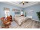 Spacious bedroom with a ceiling fan, recessed lights, wood-look tile flooring, and a wooden rocking chair at 6217 Ashley Dr, Lakeland, FL 33813