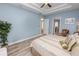Bright bedroom featuring wood-look tile flooring, a ceiling fan, recessed lights, and pale blue walls at 6217 Ashley Dr, Lakeland, FL 33813