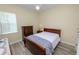 Comfortable bedroom featuring a ceiling fan, warm-toned walls, wood trim, and a window for natural light at 6217 Ashley Dr, Lakeland, FL 33813