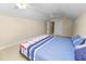 Cozy bedroom showcasing bright walls, a ceiling fan, and a comfortable-looking bed with a blue comforter at 6217 Ashley Dr, Lakeland, FL 33813