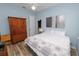 Cozy bedroom with a ceiling fan, recessed lights, wood-look tile flooring, and pale blue walls at 6217 Ashley Dr, Lakeland, FL 33813