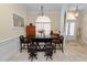 An elegant dining area features a modern table, stylish seating, and an eye-catching chandelier at 6217 Ashley Dr, Lakeland, FL 33813