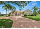 Beautiful single-Gathering home with a circular driveway, palm trees, and lush green lawn at 6217 Ashley Dr, Lakeland, FL 33813