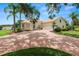 Beautiful home with a brick driveway, mature palm trees, and manicured landscaping at 6217 Ashley Dr, Lakeland, FL 33813
