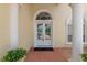 Elegant front entrance with double doors, arched transom window, and brick paver walkway at 6217 Ashley Dr, Lakeland, FL 33813