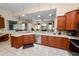 Spacious kitchen with stainless appliances, tile floors, and a view into the living room at 6217 Ashley Dr, Lakeland, FL 33813