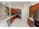This well-lit kitchen features wood cabinets, stainless steel appliances, and tile flooring at 6217 Ashley Dr, Lakeland, FL 33813