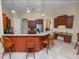 Spacious kitchen featuring a breakfast bar with seating and wooden cabinetry at 6217 Ashley Dr, Lakeland, FL 33813