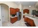 This kitchen features wood cabinets, tile flooring, stainless steel appliances, and modern lighting at 6217 Ashley Dr, Lakeland, FL 33813
