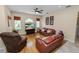 Comfortable living room with wood floors, a ceiling fan, and large windows for natural light at 6217 Ashley Dr, Lakeland, FL 33813