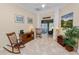 Inviting living room featuring rocking chairs, tile floors, and a view into the sunroom at 6217 Ashley Dr, Lakeland, FL 33813