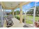 Relaxing screened-in porch with seating, offering serene views of a green lawn and open sky at 6217 Ashley Dr, Lakeland, FL 33813