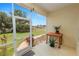 Charming screened-in porch features a tiled floor, a view of the green lawn, and manicured landscaping at 6217 Ashley Dr, Lakeland, FL 33813