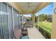 Relaxing screened-in porch featuring comfortable seating, a ceiling fan, and a view of the green lawn at 6217 Ashley Dr, Lakeland, FL 33813
