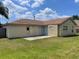 Expansive backyard featuring a well-maintained lawn and a small concrete patio at 624 Brockton Dr, Kissimmee, FL 34758