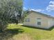 Lush green backyard with a mature tree providing shade and privacy to the property at 624 Brockton Dr, Kissimmee, FL 34758