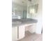 Bathroom vanity with a built in desk, drawers, and large mirrors at 624 Brockton Dr, Kissimmee, FL 34758