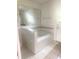 Bathroom featuring a corner garden tub, tiled flooring, and large wall mirror at 624 Brockton Dr, Kissimmee, FL 34758
