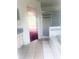 Bright bathroom with tiled floor, an enclosed shower, and a garden tub at 624 Brockton Dr, Kissimmee, FL 34758