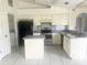 Bright kitchen with breakfast bar and black appliances at 624 Brockton Dr, Kissimmee, FL 34758