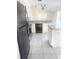 Galley kitchen featuring black appliances and light tile flooring at 624 Brockton Dr, Kissimmee, FL 34758