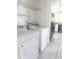 Laundry room with a white washer and dryer appliances and tiled floors at 624 Brockton Dr, Kissimmee, FL 34758