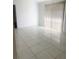Minimalist living room featuring bright tile flooring and a large window at 624 Brockton Dr, Kissimmee, FL 34758
