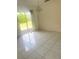 Living room with tile flooring, light fixture, and sliding glass door at 624 Brockton Dr, Kissimmee, FL 34758