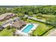 Aerial view of a neighborhood pool and clubhouse with surrounding landscaping and lush green space at 6365 Torrington Cir, Lakeland, FL 33811