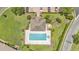 Aerial view of a community pool surrounded by green lawns and neatly manicured landscaping at 6365 Torrington Cir, Lakeland, FL 33811