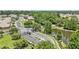 Scenic aerial view of gated community entrance near lush woods and a tranquil pond at 6365 Torrington Cir, Lakeland, FL 33811