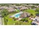 A beautiful community pool and clubhouse are surrounded by lush landscaping and well-maintained homes at 6365 Torrington Cir, Lakeland, FL 33811