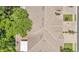 Overhead view of a roof showing shingles, vents, landscaping, and proximity to a neighboring building at 6365 Torrington Cir, Lakeland, FL 33811