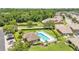 Aerial view of community pool with a sun deck near lush landscaping and residences at 6365 Torrington Cir, Lakeland, FL 33811