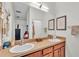 Bathroom features a double sink vanity with a large mirror and ample counter space at 6365 Torrington Cir, Lakeland, FL 33811