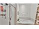 Modern bathroom features a shower with glass door and a soaking tub, perfect for relaxation at 6365 Torrington Cir, Lakeland, FL 33811