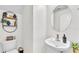 Charming powder room with modern fixtures, pedestal sink, and stylish decor at 6365 Torrington Cir, Lakeland, FL 33811