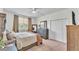 Bright bedroom with a large window, a dresser, and a comfortable bed at 6365 Torrington Cir, Lakeland, FL 33811