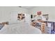 Stylish bedroom featuring a white comforter, a vanity table, and ample storage at 6365 Torrington Cir, Lakeland, FL 33811