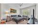 Cozy bedroom featuring a ceiling fan, a mini-fridge, and a comfortable couch at 6365 Torrington Cir, Lakeland, FL 33811