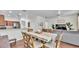 Charming dining area featuring a large table, hardwood floors, and seamless connection to the kitchen at 6365 Torrington Cir, Lakeland, FL 33811