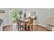 Bright dining area with hardwood floors, table, and sliding glass doors to a screened patio at 6365 Torrington Cir, Lakeland, FL 33811