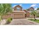 Charming townhome featuring a brick driveway, a two-car garage, and lush tropical landscaping at 6365 Torrington Cir, Lakeland, FL 33811