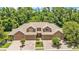 Exterior of a multi-unit building featuring a symmetrical design, three garage doors, and well-kept landscaping at 6365 Torrington Cir, Lakeland, FL 33811